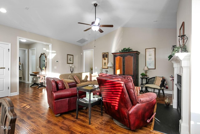 living room with a fireplace, visible vents, a ceiling fan, vaulted ceiling, and wood finished floors