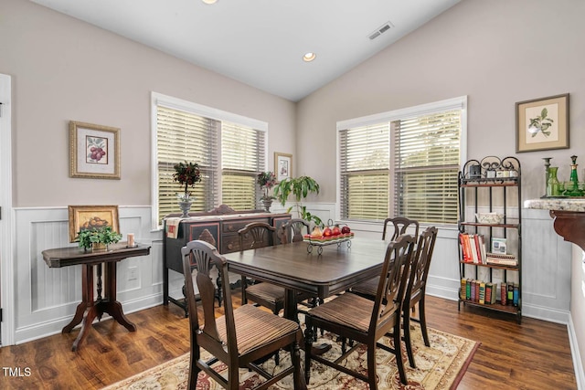 dining space featuring lofted ceiling, recessed lighting, visible vents, wainscoting, and wood finished floors