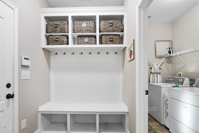 mudroom with washer and clothes dryer and stone finish floor