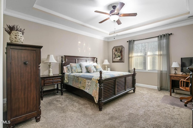 bedroom featuring baseboards, a raised ceiling, a ceiling fan, light colored carpet, and crown molding