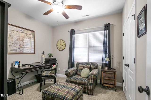 carpeted office space featuring a ceiling fan, visible vents, and baseboards