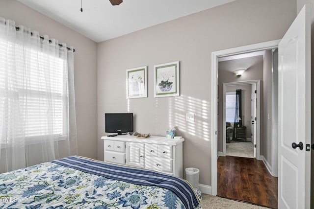 carpeted bedroom featuring ceiling fan and baseboards