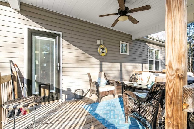 wooden terrace featuring a ceiling fan and an outdoor hangout area