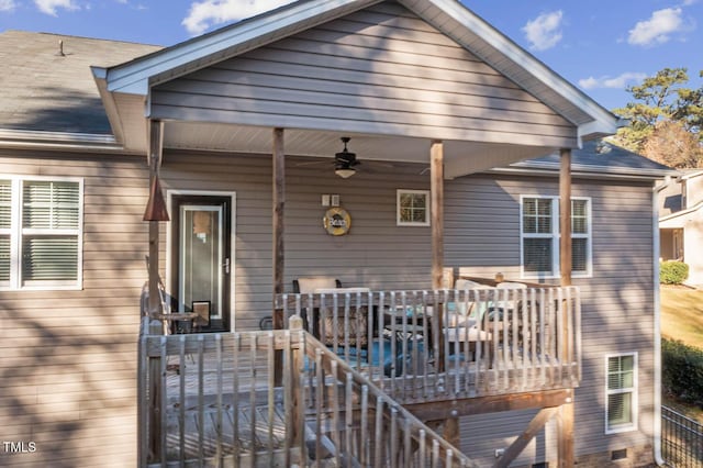 exterior space with a shingled roof and a ceiling fan