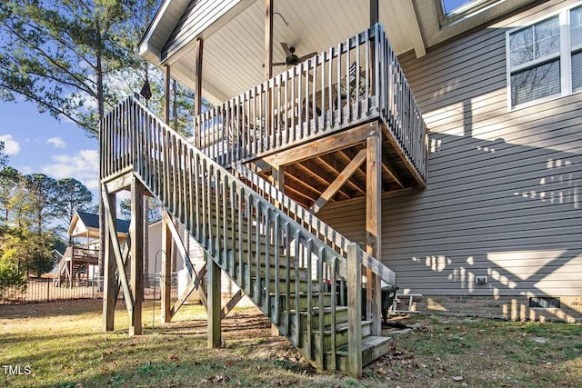 view of side of home with crawl space, stairs, a ceiling fan, and a wooden deck