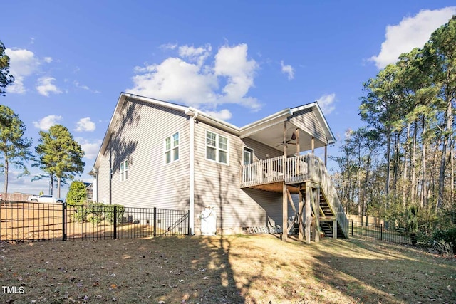 rear view of house with a ceiling fan, a fenced backyard, and stairway