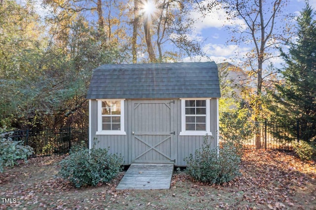 view of shed featuring fence