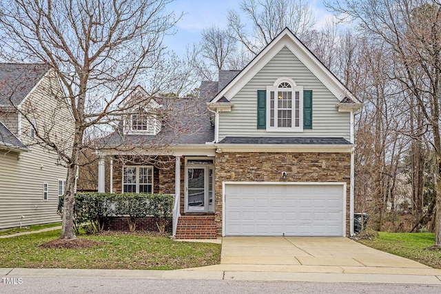 traditional-style home featuring concrete driveway, a garage, stone siding, and a shingled roof