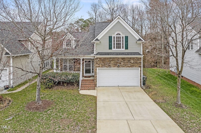 traditional-style home with stone siding, an attached garage, concrete driveway, and a front lawn