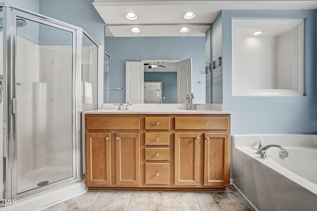 bathroom featuring a garden tub, a stall shower, and a sink