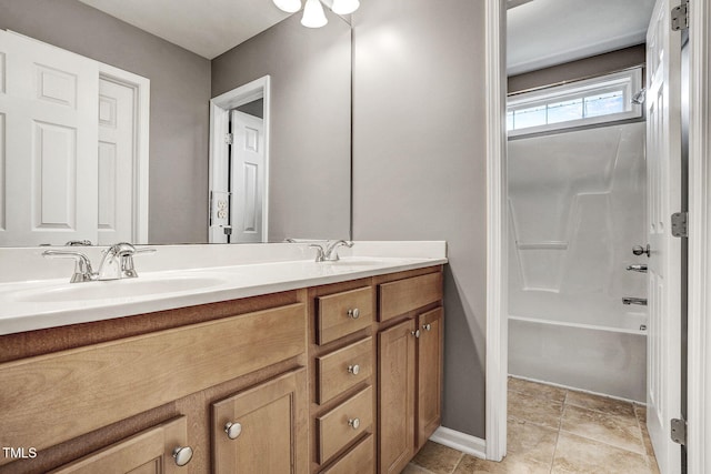 full bathroom with a sink, baseboards, bathing tub / shower combination, and double vanity