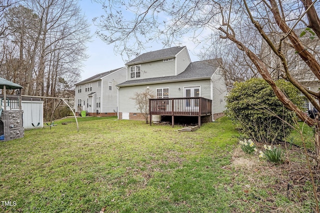 back of house featuring crawl space, a deck, a yard, and roof with shingles