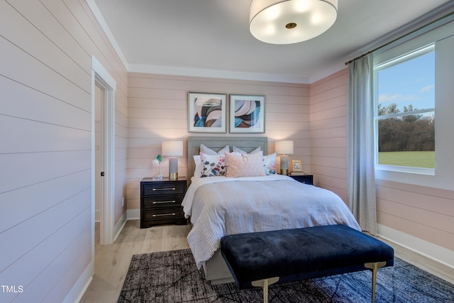 bedroom with light wood-style floors and baseboards