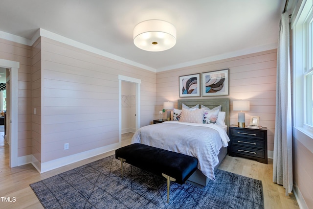 bedroom featuring light wood-style flooring and baseboards