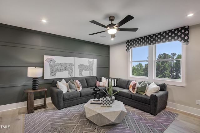 living area with ceiling fan, recessed lighting, wood finished floors, and baseboards