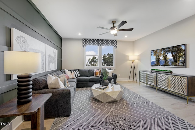 living area with a ceiling fan, recessed lighting, baseboards, and light wood finished floors