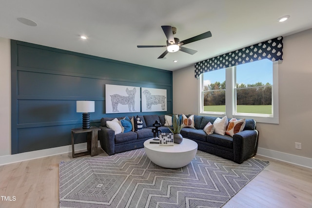 living area featuring a ceiling fan, baseboards, wood finished floors, and recessed lighting