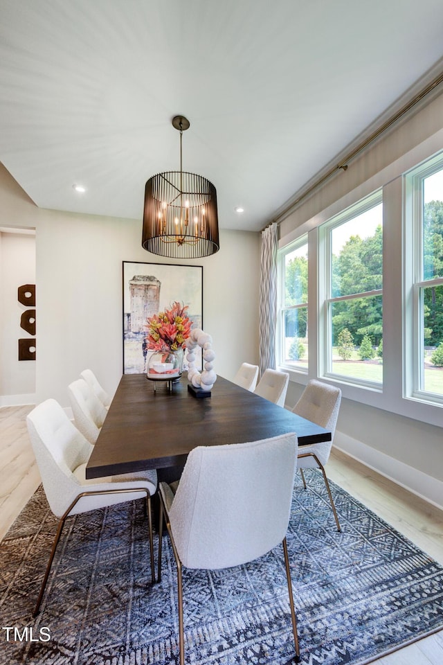 dining area featuring recessed lighting, a notable chandelier, baseboards, and wood finished floors