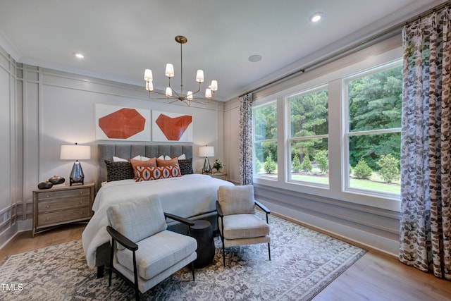 bedroom with recessed lighting, wood finished floors, and an inviting chandelier