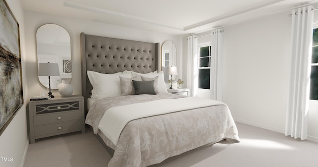 carpeted bedroom featuring a tray ceiling and baseboards