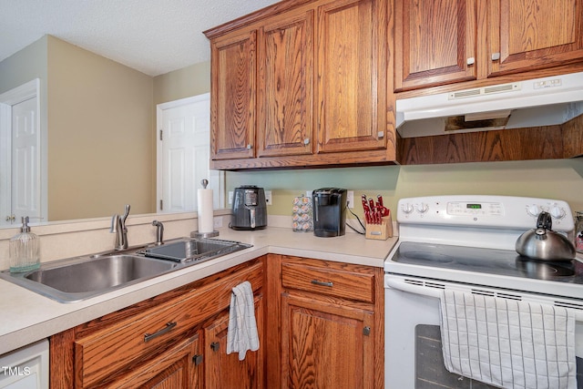 kitchen with under cabinet range hood, a sink, light countertops, white range with electric stovetop, and brown cabinets