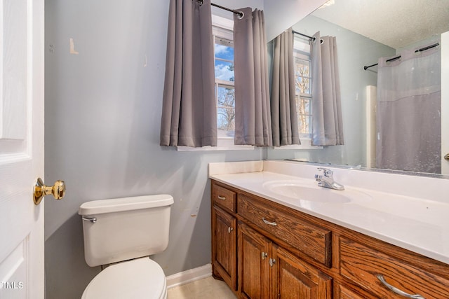 full bathroom with toilet, baseboards, a textured ceiling, and vanity