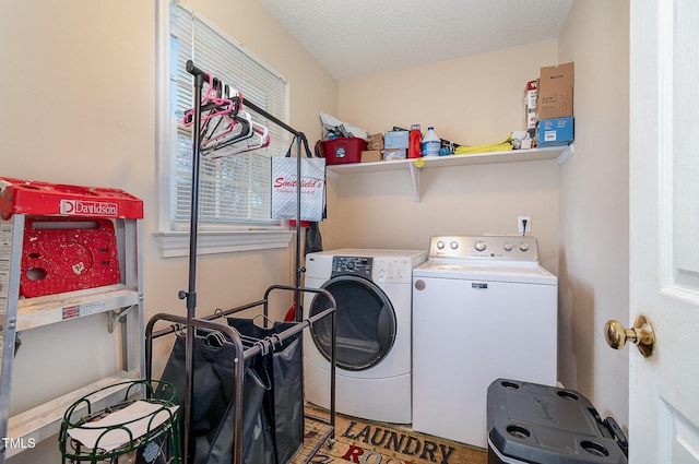 laundry room with washing machine and dryer, laundry area, and a textured ceiling