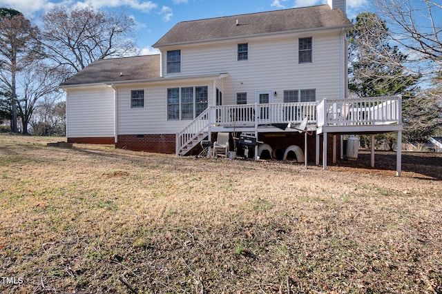 back of property featuring crawl space, a yard, a chimney, and a wooden deck