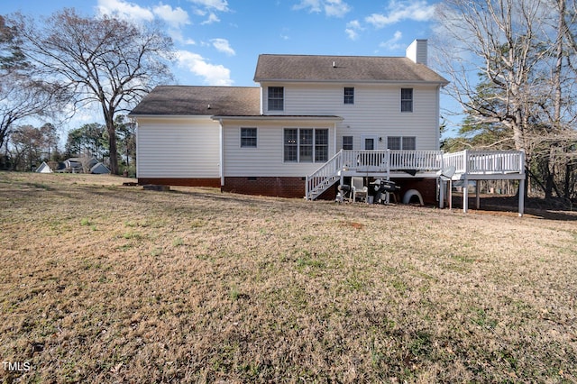 back of house with a deck, a yard, stairway, and a chimney