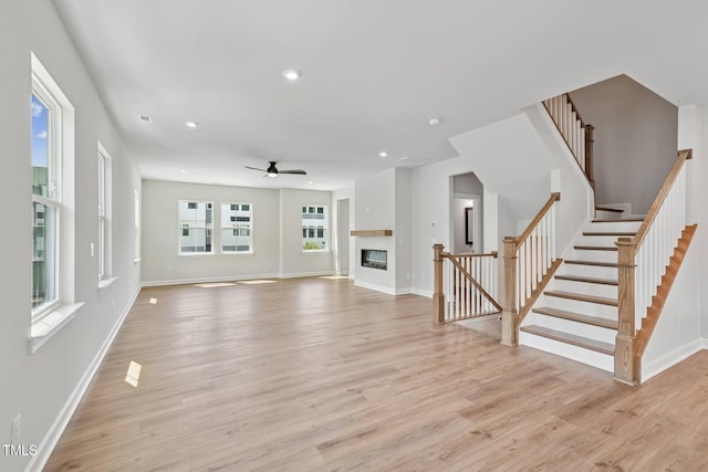 4706 Cypress Tree Ln, Raleigh, NC 27612 - unfurnished living room featuring ceiling fan, light wood-type flooring, baseboards, stairway, and recessed lighting