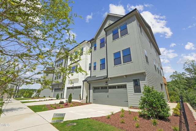 4706 Cypress Tree Ln, Raleigh, NC 27612 - view of front facade with board and batten siding, driveway, and a garage