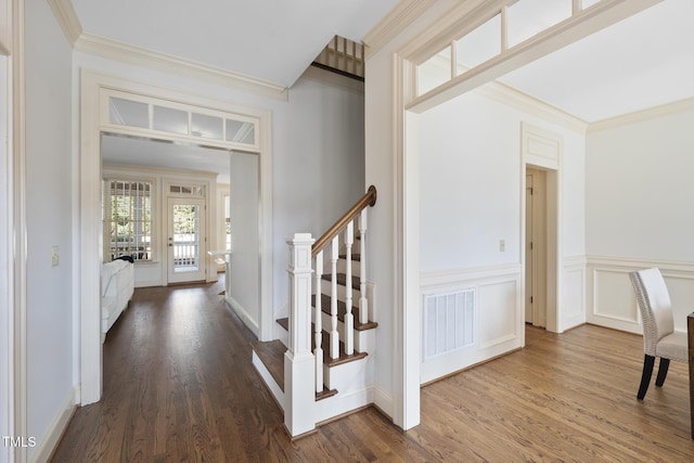 corridor featuring visible vents, stairway, dark wood-type flooring, and ornamental molding