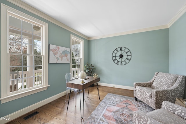 office space with visible vents, baseboards, and wood finished floors