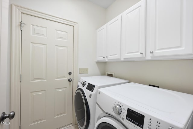 laundry room featuring cabinet space and washing machine and dryer