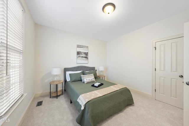 bedroom with visible vents, baseboards, and carpet