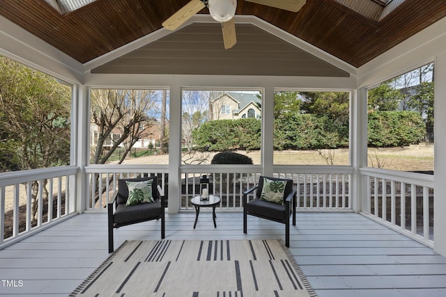 sunroom with a ceiling fan, vaulted ceiling, and wood ceiling