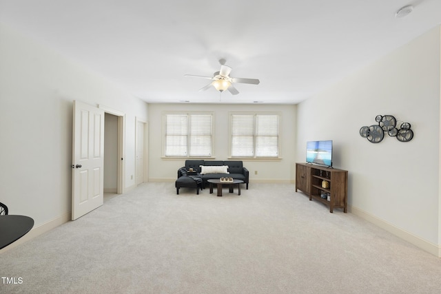 sitting room featuring ceiling fan, baseboards, and carpet floors