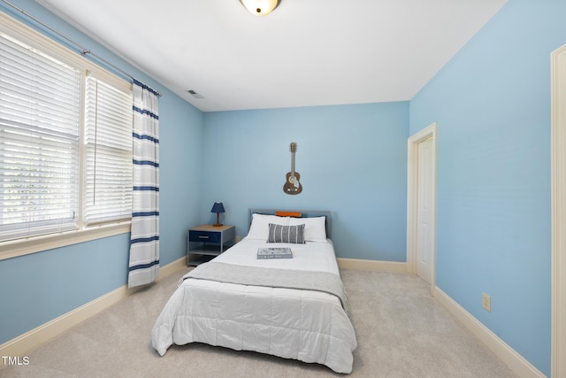 bedroom with visible vents, carpet flooring, and baseboards