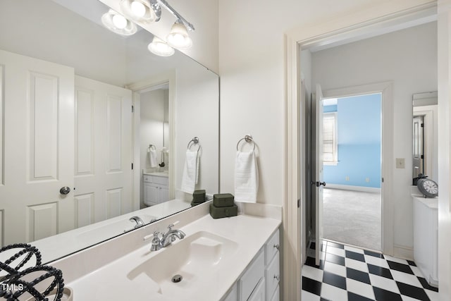 bathroom featuring tile patterned floors, vanity, and baseboards