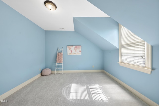 bonus room with visible vents, baseboards, carpet, and vaulted ceiling