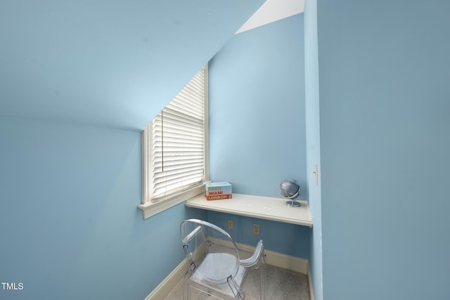 home office featuring baseboards and built in desk