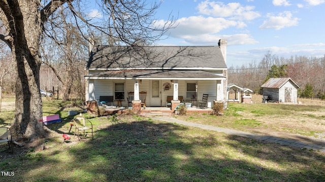 2710 Morton Pulliam Rd, Roxboro, NC 27574 - view of front facade featuring covered porch, a shingled roof, a chimney, and a front yard