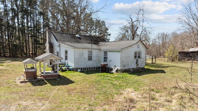 2710 Morton Pulliam Rd, Roxboro, NC 27574 - back of property with a chimney, a lawn, and a shingled roof