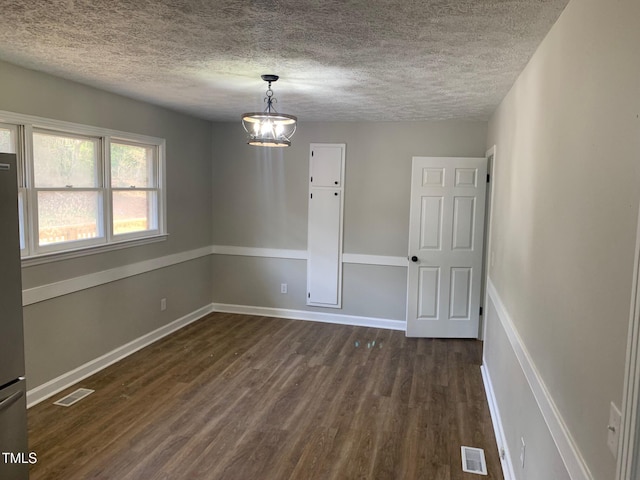 spare room with visible vents, dark wood finished floors, and baseboards