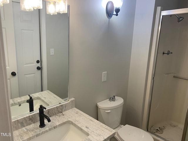 full bathroom featuring toilet, a shower stall, a chandelier, and vanity
