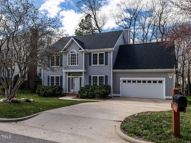 colonial house featuring roof with shingles, driveway, a chimney, and an attached garage