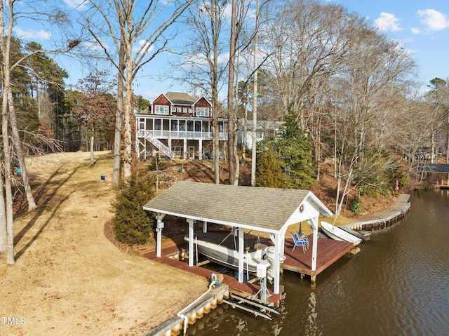 dock area with a water view, boat lift, and stairs