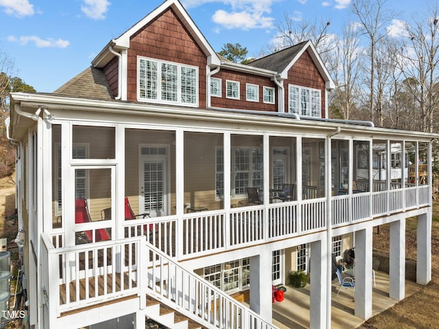 exterior space featuring stairs and a sunroom