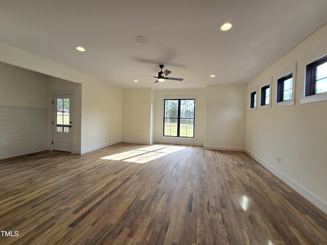 unfurnished room with recessed lighting, a healthy amount of sunlight, and wood finished floors