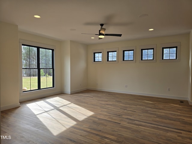 spare room with recessed lighting, wood finished floors, baseboards, and ceiling fan